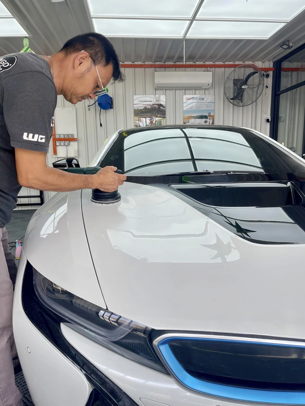 Technician polishing a BMW at WG Detailing