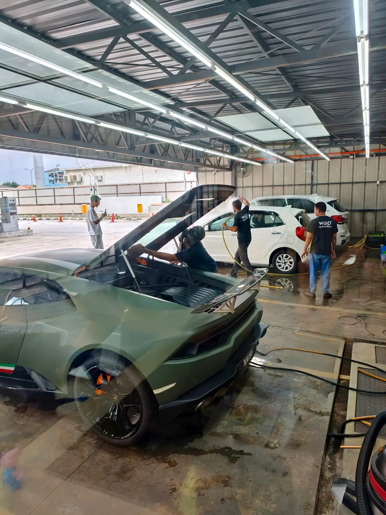 WG Detailing Cheras crew carefully washing a performance car