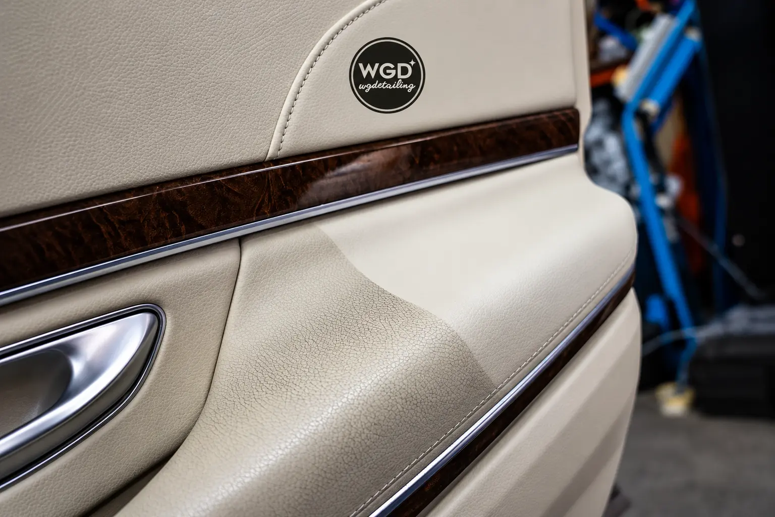 Beige leather door panel showing the difference after interior deep cleaning by WG Detailing
