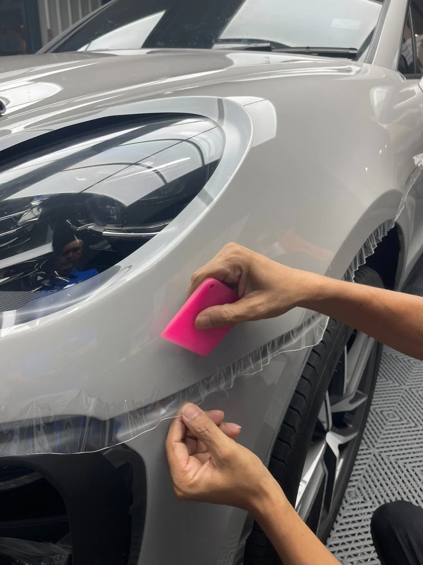 Paint protection film being installed on a car